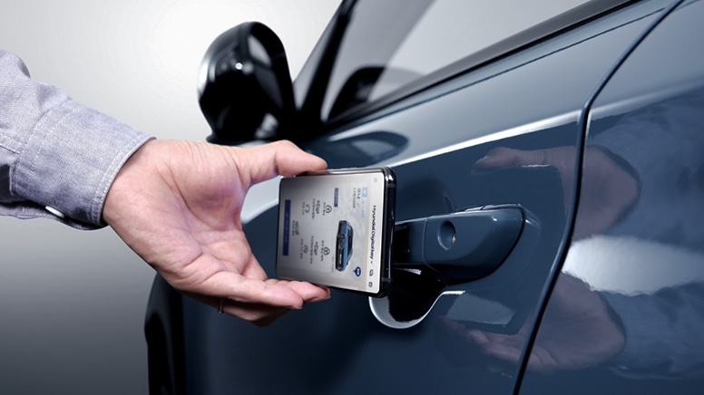 Driver unlocking Hyundai KONA with smartphone Hyundai Digital Key app