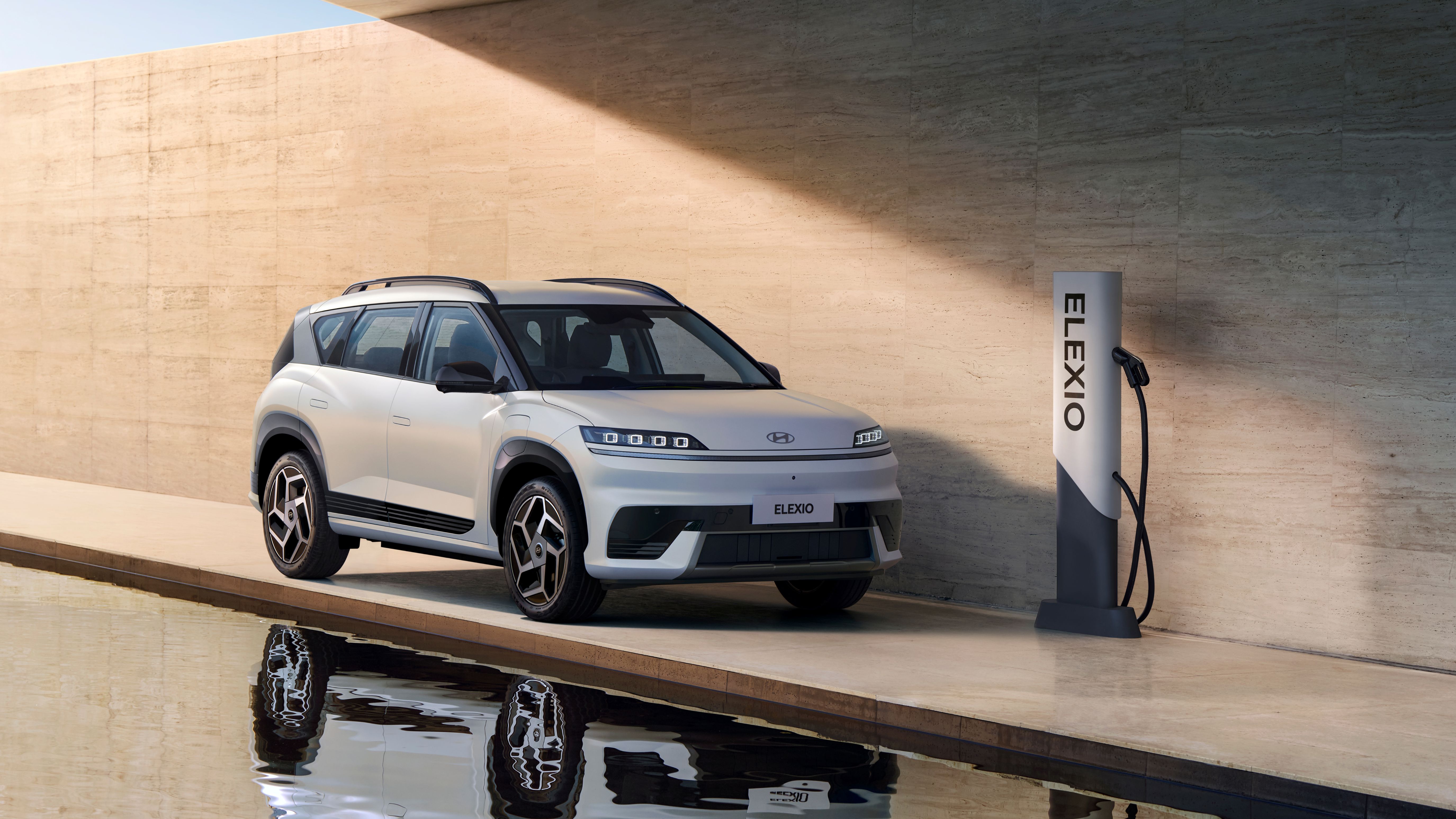The rear view of the IONIQ 9 driving around town.